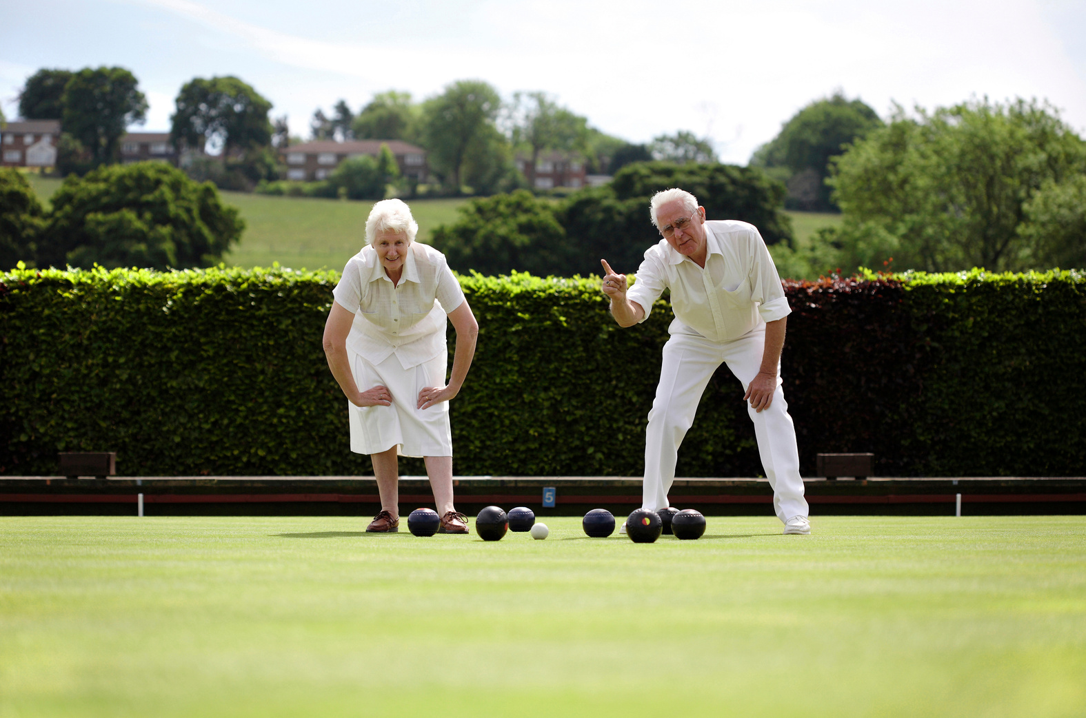 Senior couple lawn bowling in the bowling green